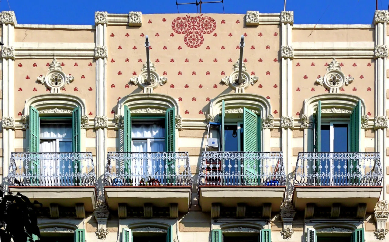 Ornamental Eclectic Facade with Balconies and Green Shutters