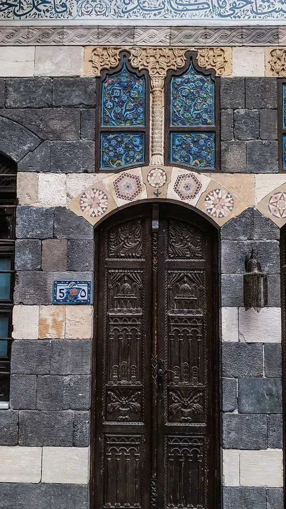 Damascus ablaq-style facade: contrasting stonework and traditional Islamic decorative elements