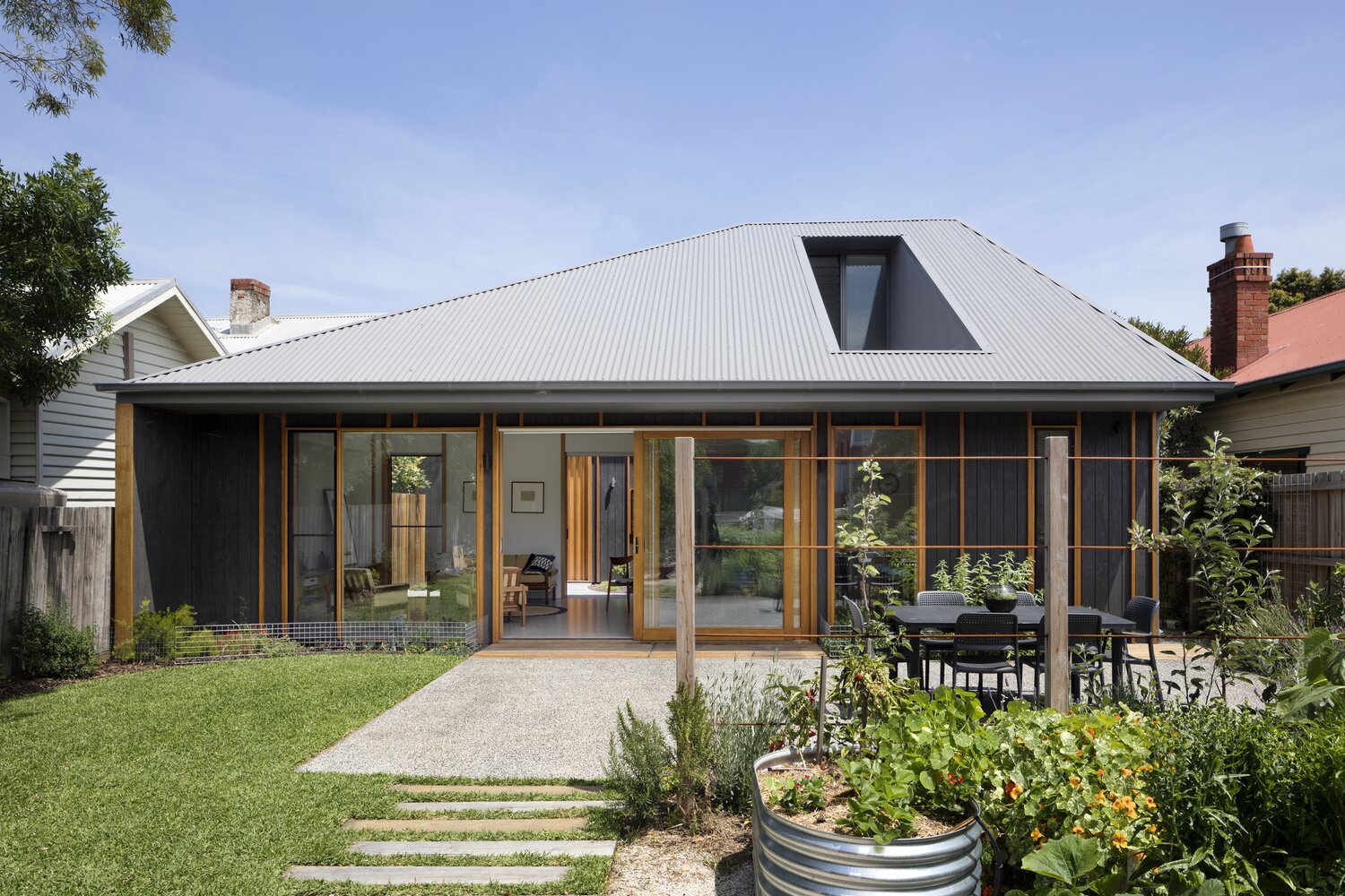 Modern facade with panoramic glazing: contrast of metal and wood