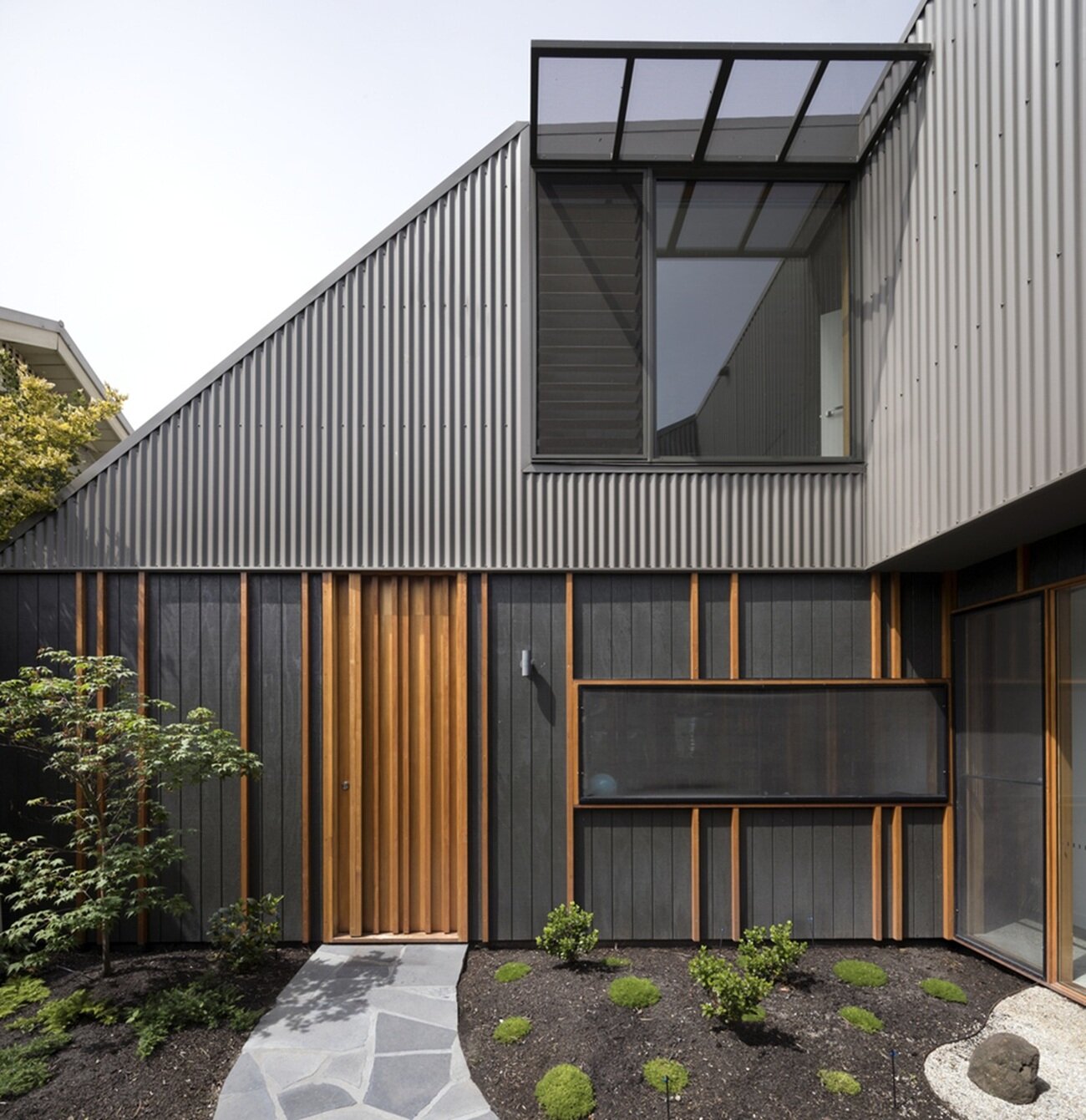 Modern facade with contrasting combination of metal and wood