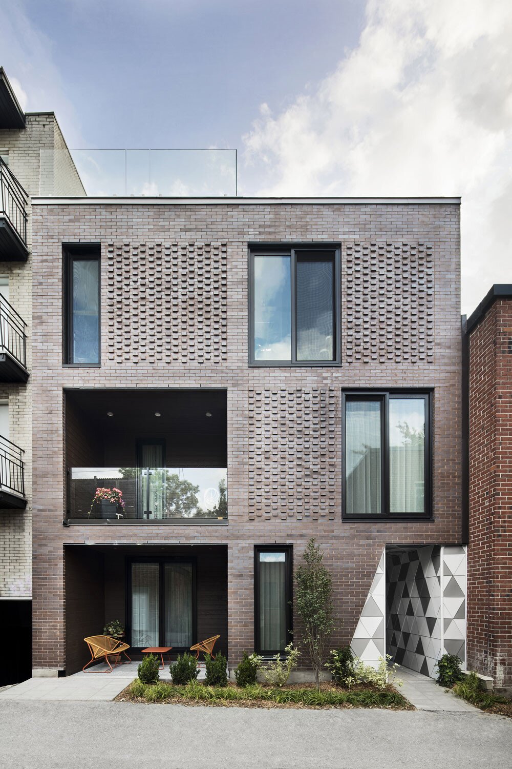 Modern brick facade with textured elements and geometric accents