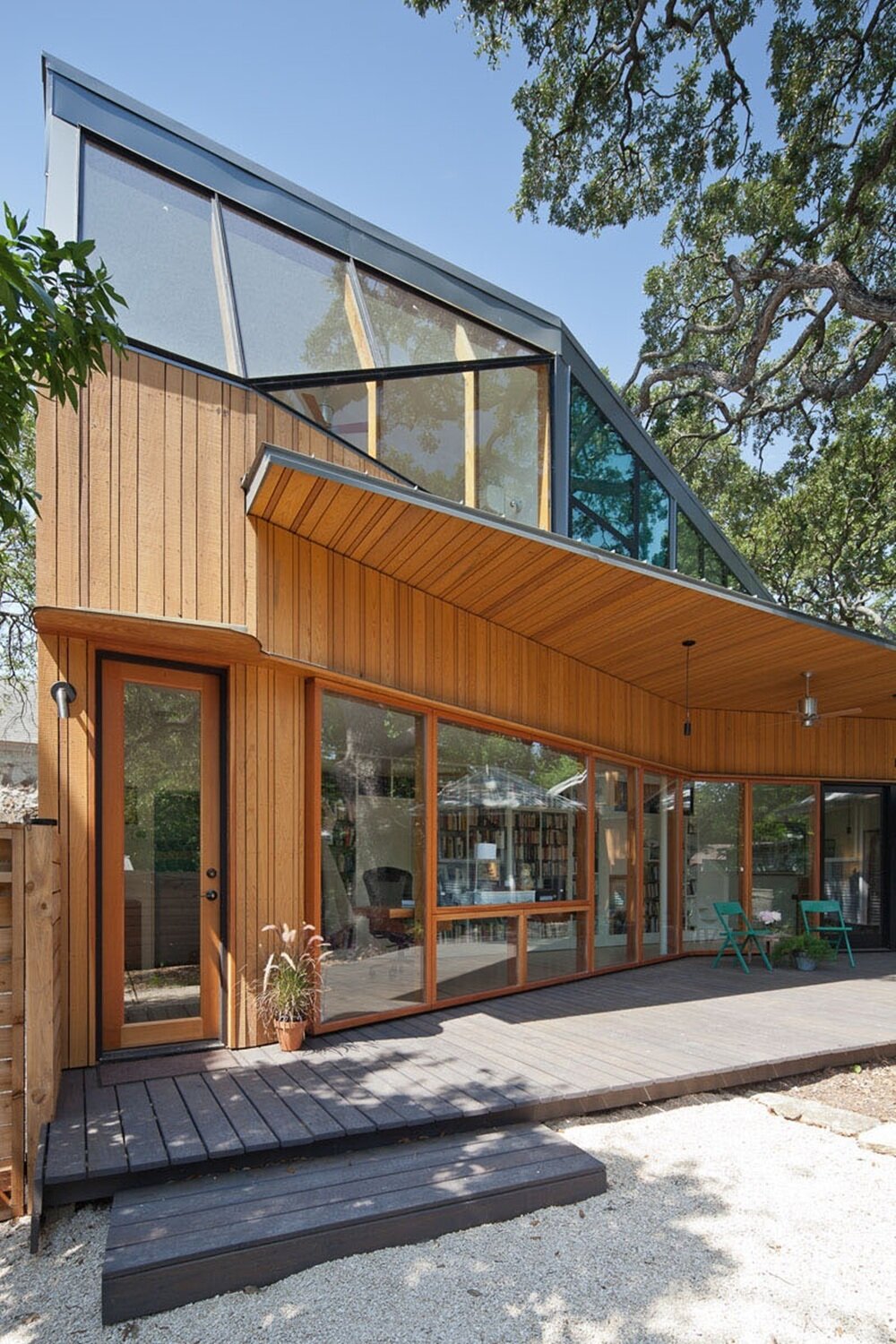 Modern wooden facade with asymmetrical roof and panoramic glazing