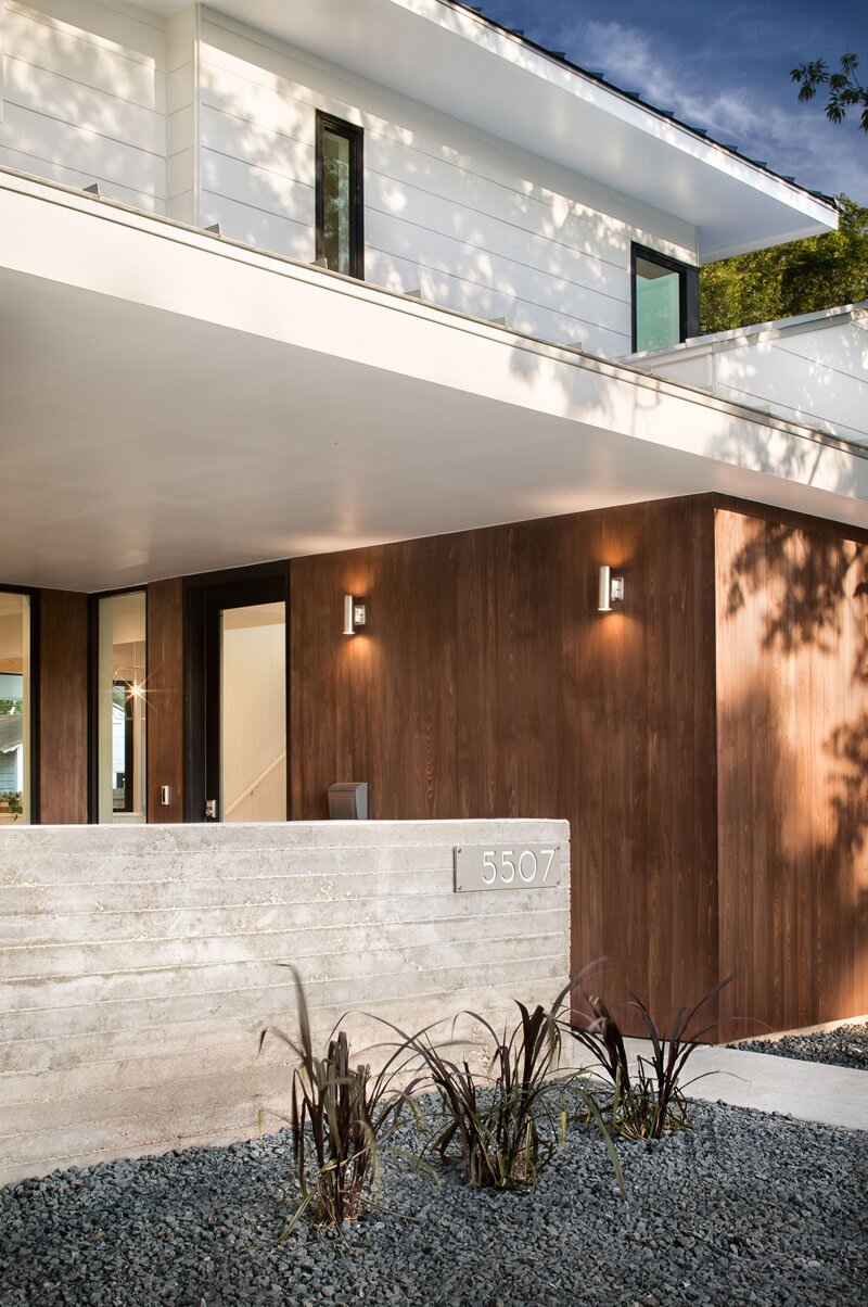 Modern two-tone facade with contrasting white panels and wooden cladding