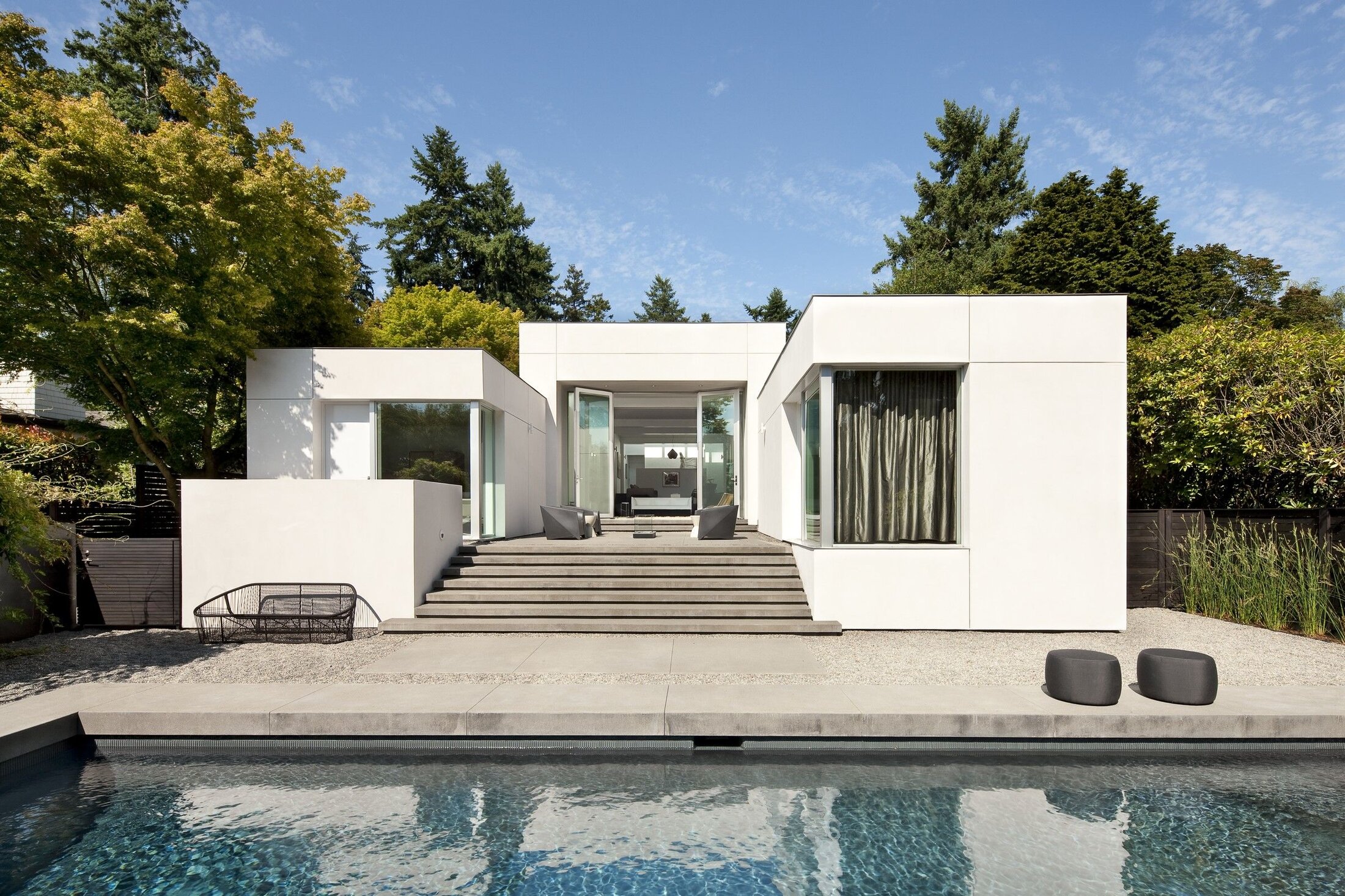 Snow-white minimalist facade with panoramic glazing