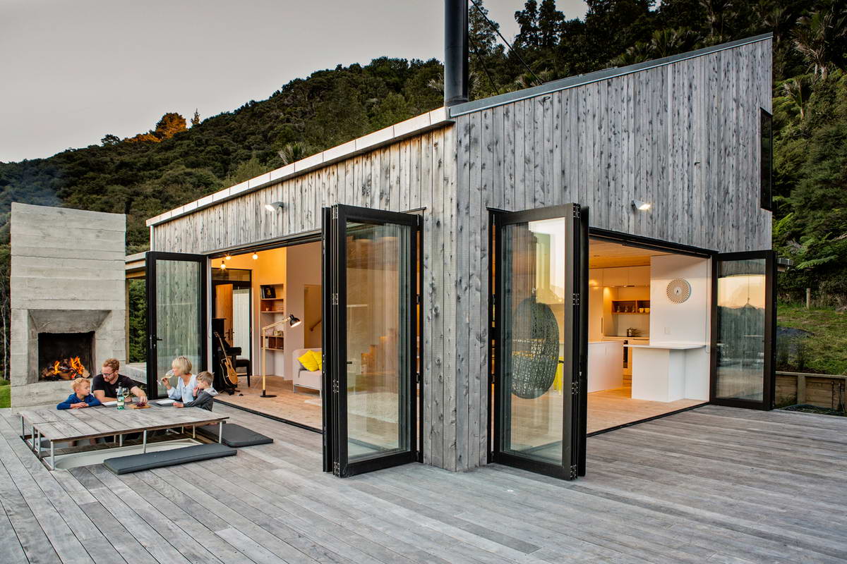 Modern wooden facade with sliding glass doors and asymmetric roof