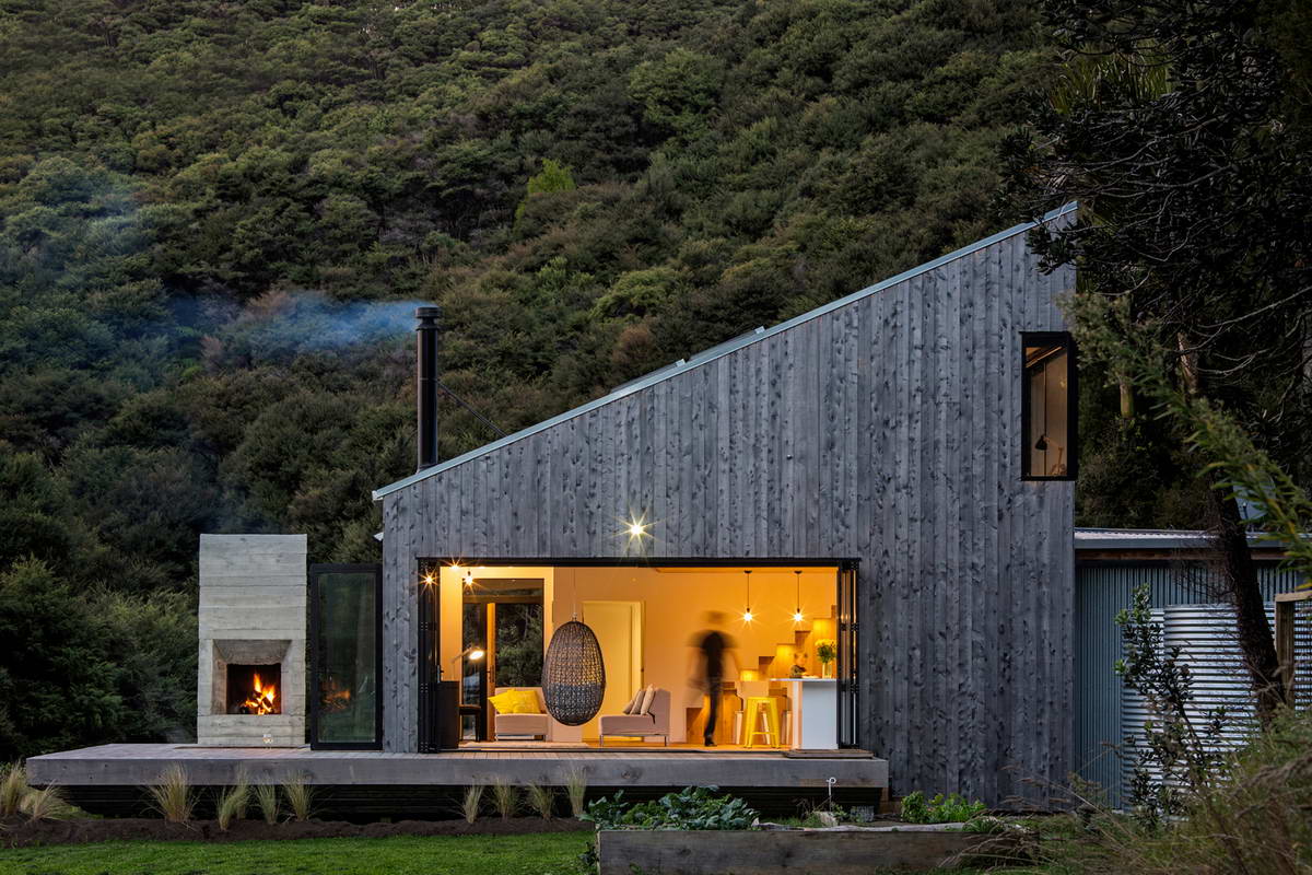 Modern forest house with vertical wooden facade and mono-pitched roof