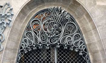 Musical Façade: Filigree Ironwork with Lyre Motif in Arched Frame