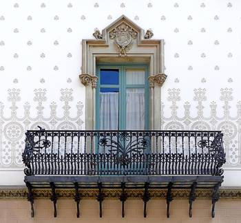 Elegant Art Nouveau Facade with Ornamental Wall and Wrought Iron Elements