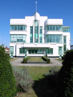 Modernist Church Facade with Turquoise Glazing and Symmetrical Bay Windows