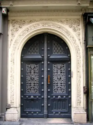 Historic facade with decorative arched portal and ornate blue door