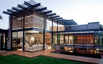 Transparent Façade: Modern Mansion with Wooden Louvers and Panoramic Glazing