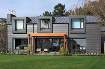 Industrial Minimalism: Gray Metal Facade with Wooden Pergola