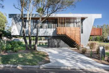 Floating Metal Facade with Warm Wooden Accents