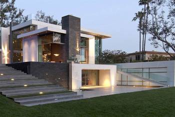 Modern mansion with contrasting glass and stone facade