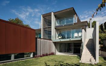 Contrasting Facade with Louvers: Modern Three-Level House with Panoramic Glazing