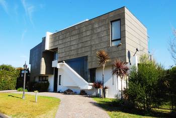 Contrasting Facade: Modern House with Dark Gray Cladding and White Diagonal Staircase