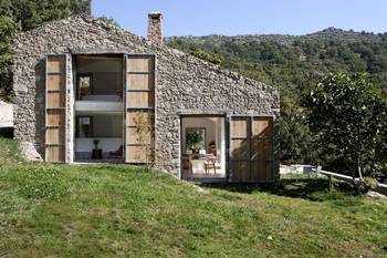 Stone Facade with Wooden Shutters: Harmony of Tradition and Modernity in a Mountain Retreat