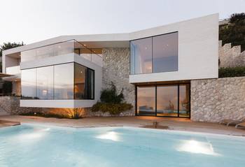 Binary Facade: Harmony of White Minimalism and Natural Stone