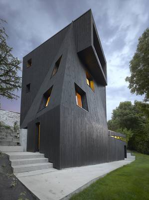 Black Wooden Facade: A Sculptural Tower with Dynamic Geometry