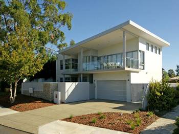 Minimalist White Facade: Contemporary House with Terrace and Glass Railing