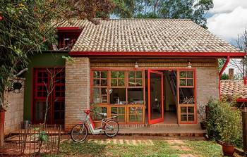 Rustic Charm: Brick Facade with Vibrant Red Accents