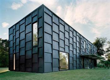 Textured Dark Façade: Monolithic Form and Geometry in Natural Surroundings