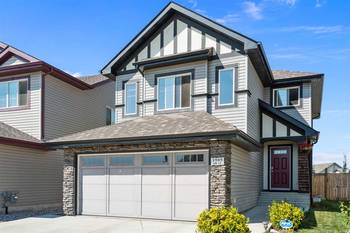 Modern Suburban House with Combined Facade: Siding, Stone, and Tudor Elements