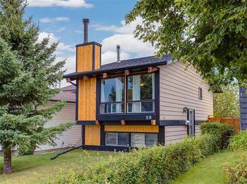 Modern two-story house with a contrasting façade of wood, metal, and siding