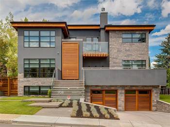 Modern Three-Level Facade with Contrasting Blend of Stone, Wood, and Stucco