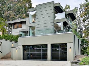 Modern three-story house with minimalist facade and panoramic glazing