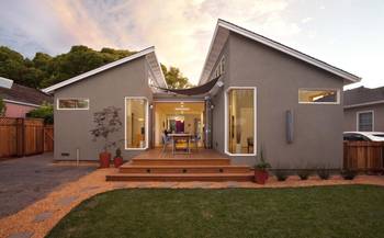 Modern Gray Façade with Asymmetrical Gable Roof and Integrated Terrace