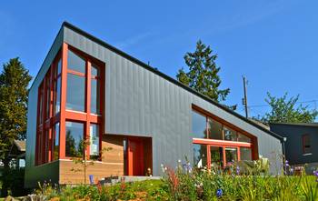 Modern Contrasting Façade: Gray Metal with Orange Accents