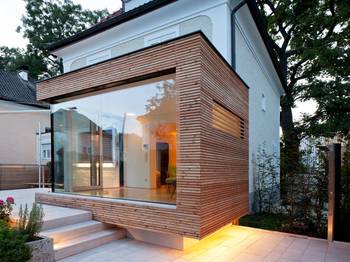 Harmonious Contrast: Modern Wooden Facade as an Extension to a Traditional Home