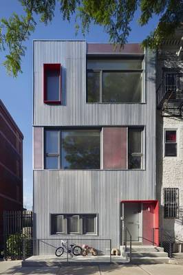 Industrial Facade with Red Accents: Metal Aesthetics in an Urban Environment