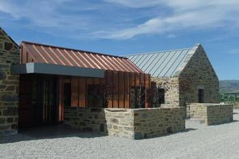 Modern stone house with copper accent facade