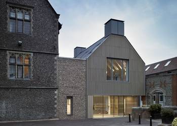 Harmonious Contrast: Historical Stone and Modern Wooden Slatted Façade