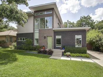 Modern two-story facade with contrasting materials and minimalist design