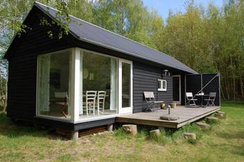 Black minimalist facade with panoramic glazing in Scandinavian style