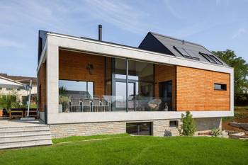 Modern facade with contrasting combination of concrete, wood, and glass