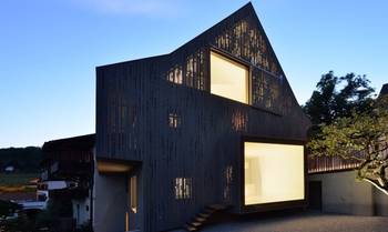 Dark Perforated Facade with Contrasting Light Apertures