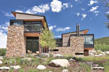 Contemporary Mountain Facade: Harmony of Stone and Wood in Natural Surroundings