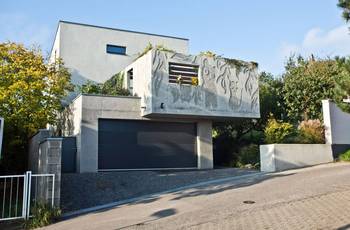 Modernist Concrete Facade with Artistic Relief and Cantilevered Volume