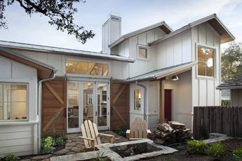 Modern Farmhouse Facade: Contrast of Light Siding and Warm Wood