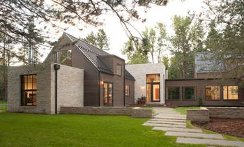 Modern country house with contrasting stone and wood facade