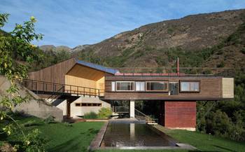 Mountain House with Cantilevered Wooden Facade