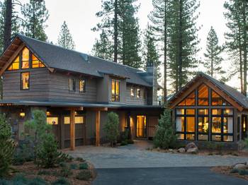 Mountain residence with expressive wooden facade and panoramic glazing