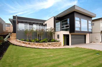 Modern two-level house with contrasting facade and terraced landscape