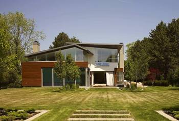 Modern Country Facade: Contrasting Materials and Nature Integration