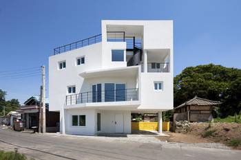 White Minimalist Facade: Geometry of Light and Cantilevered Volumes