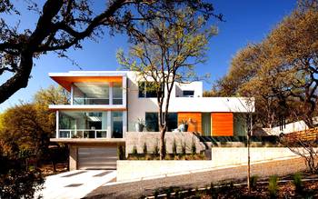 Minimalist facade with contrasting white walls and warm wood